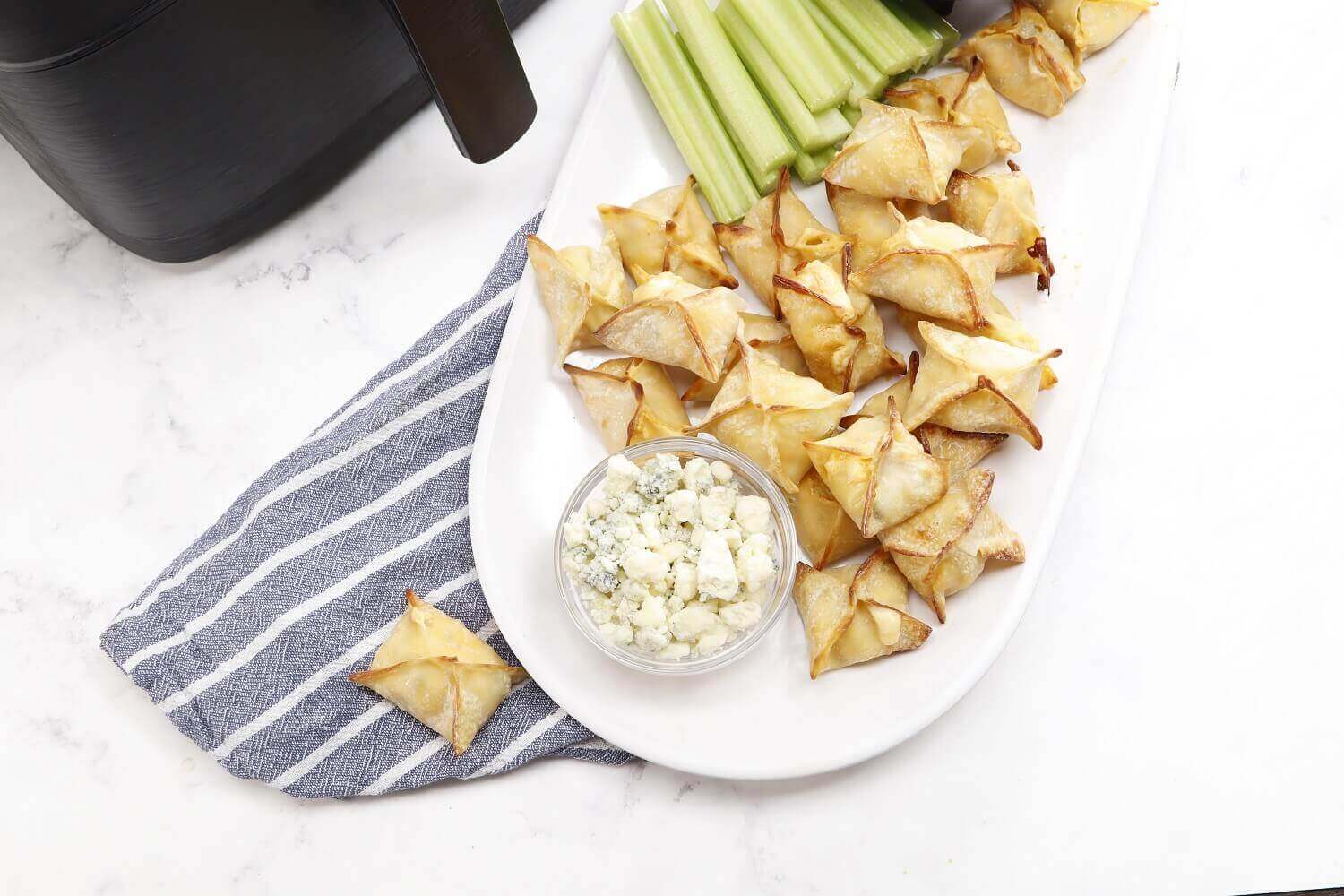 Crumbled blue cheese complements these wontons Crumbled blue cheese complements these wontons