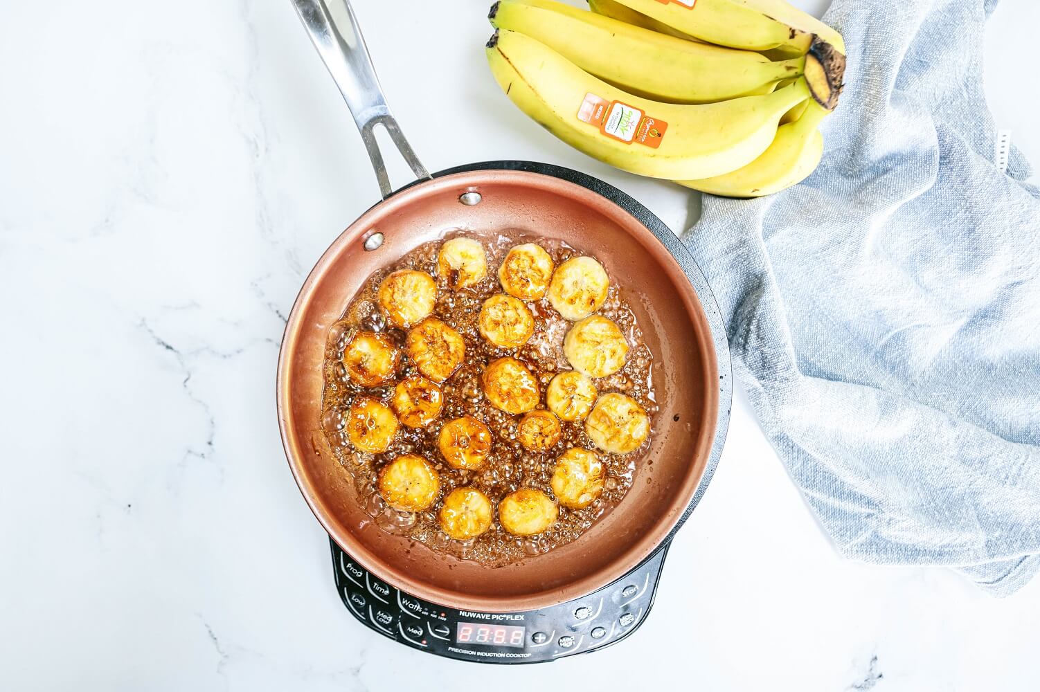 Bananas caramelizing in a pan
