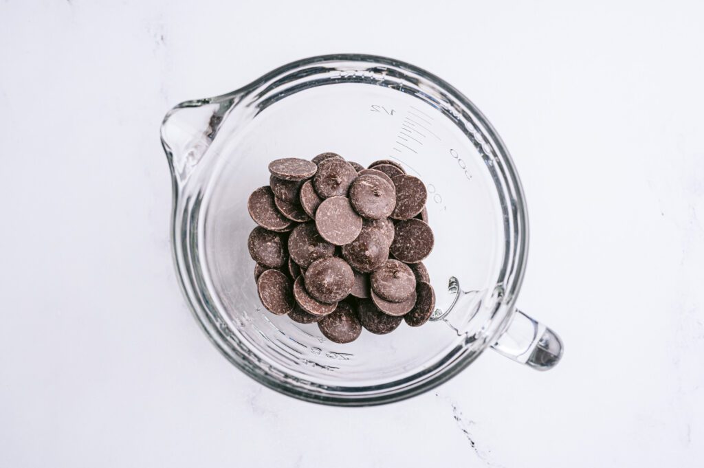 horizontal image of chocolate chips in glass mixing bowl