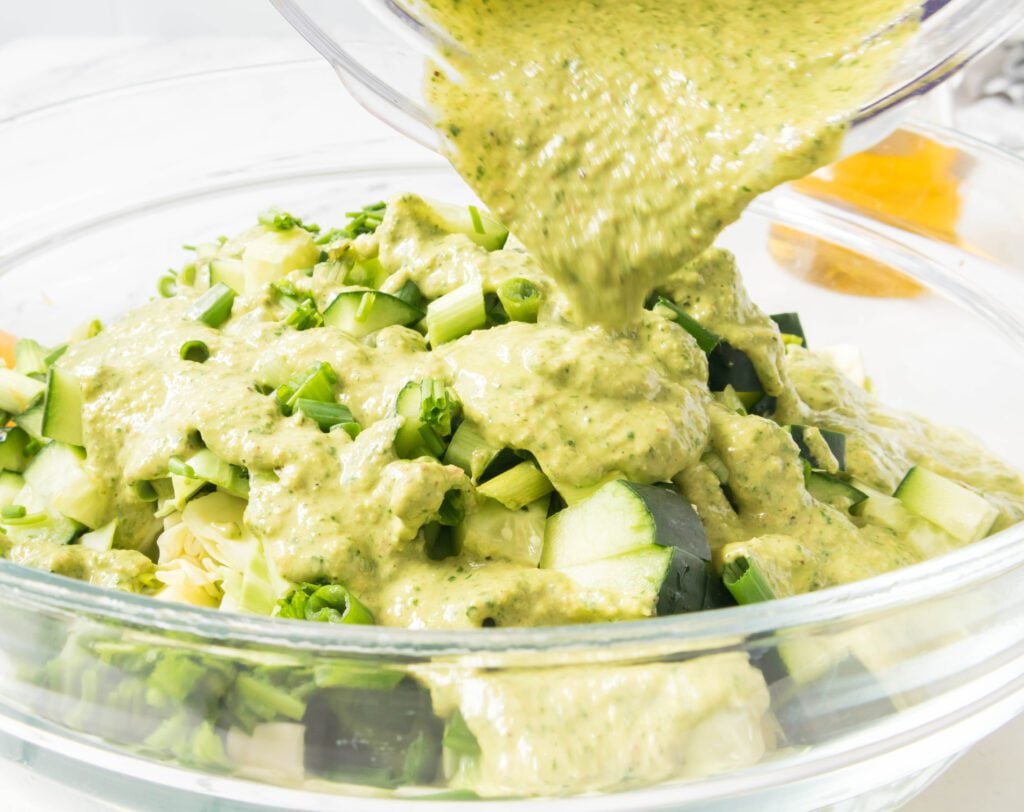 Pouring of the Salad Dressing on the Green Goddess Salad