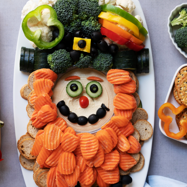 Tray of vegetables: bell peppers, broccoli, cauliflower, bell peppers, black olives, carrot chips