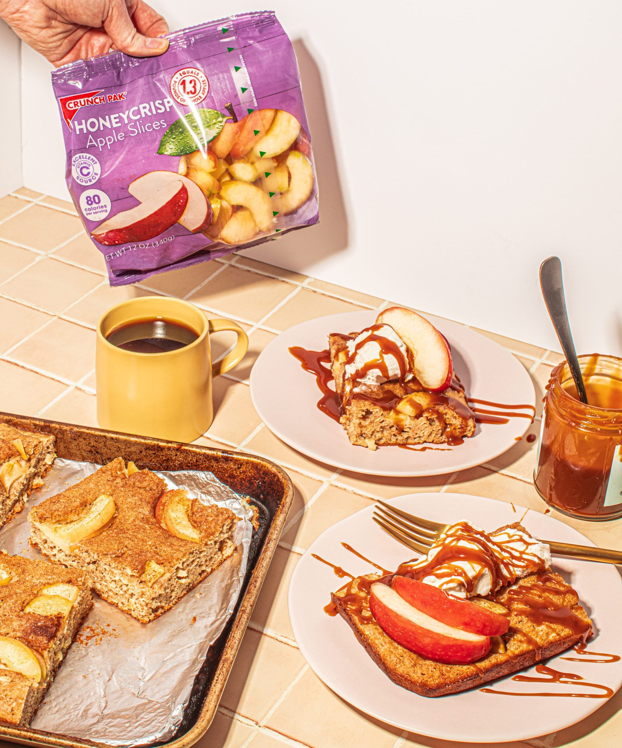 Sheet pan apple pancakes with a bag of Crunch Pak apples and a cup of coffee