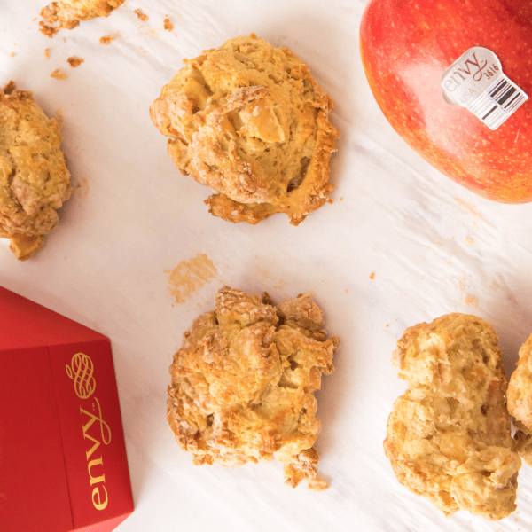 Envy Apple Drop Biscuits on parchment paper with Envy box