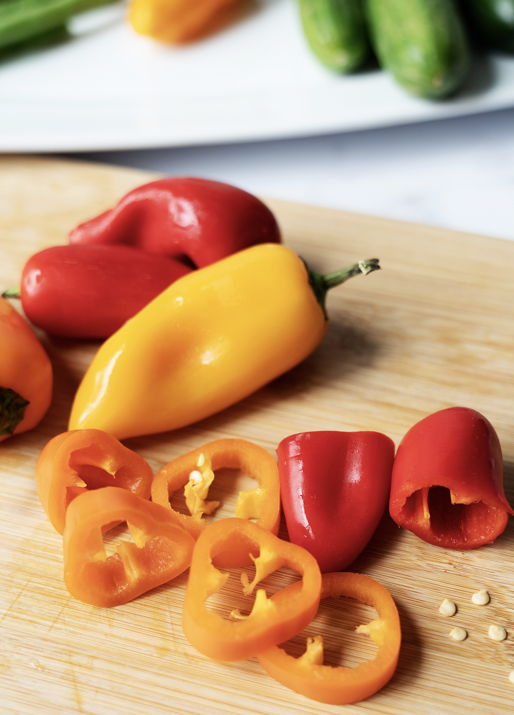 Sliced mini peppers on cutting board