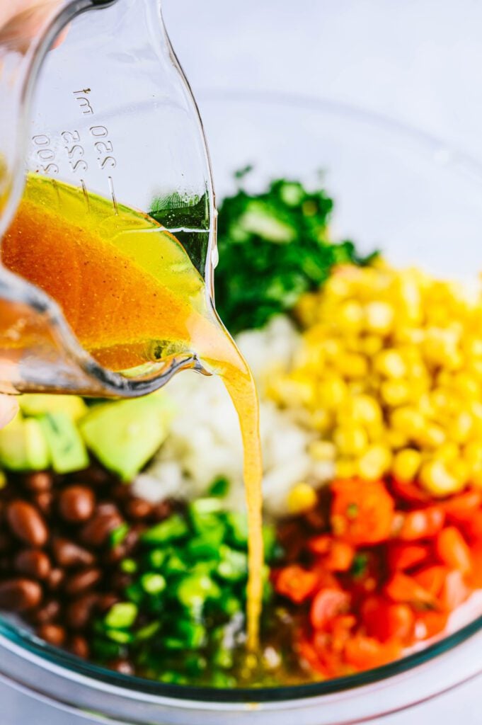 dressing pouring into veggies