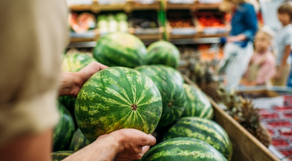 picking watermelon at a grocery store