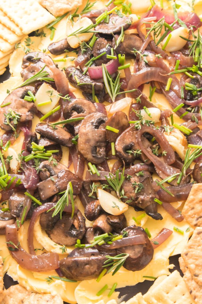 close up shot of a butter board with mushrooms and onions