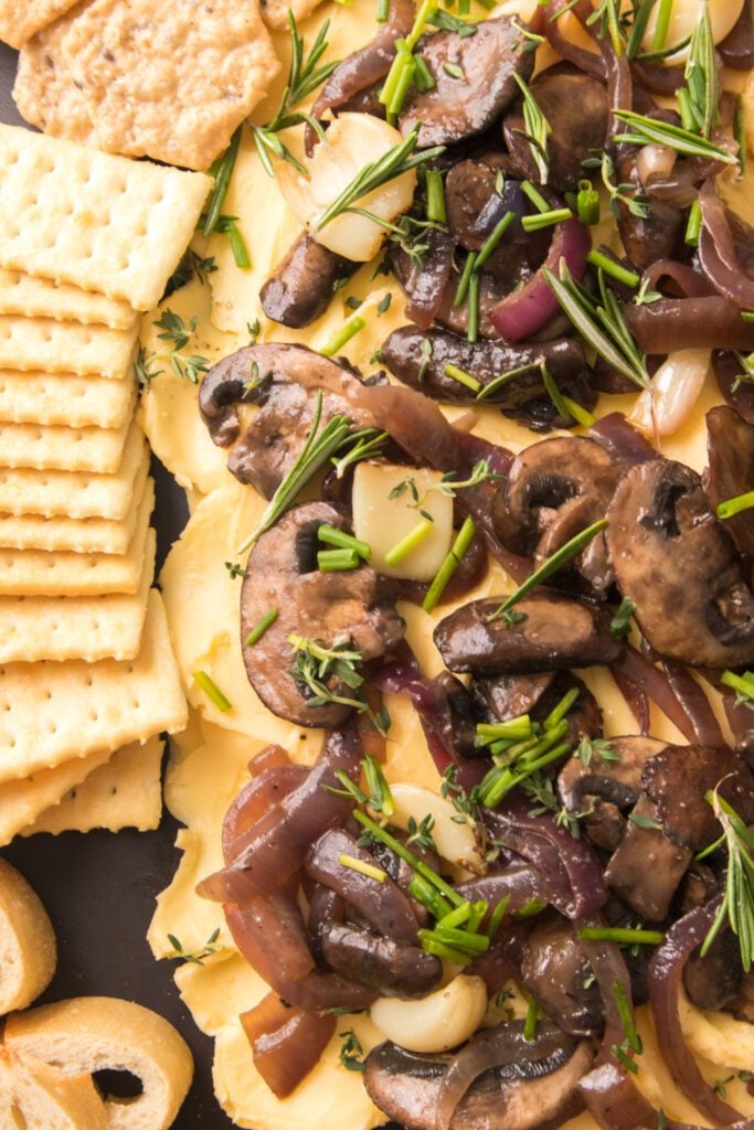 butter board with mushrooms and onions, herbs and crackers