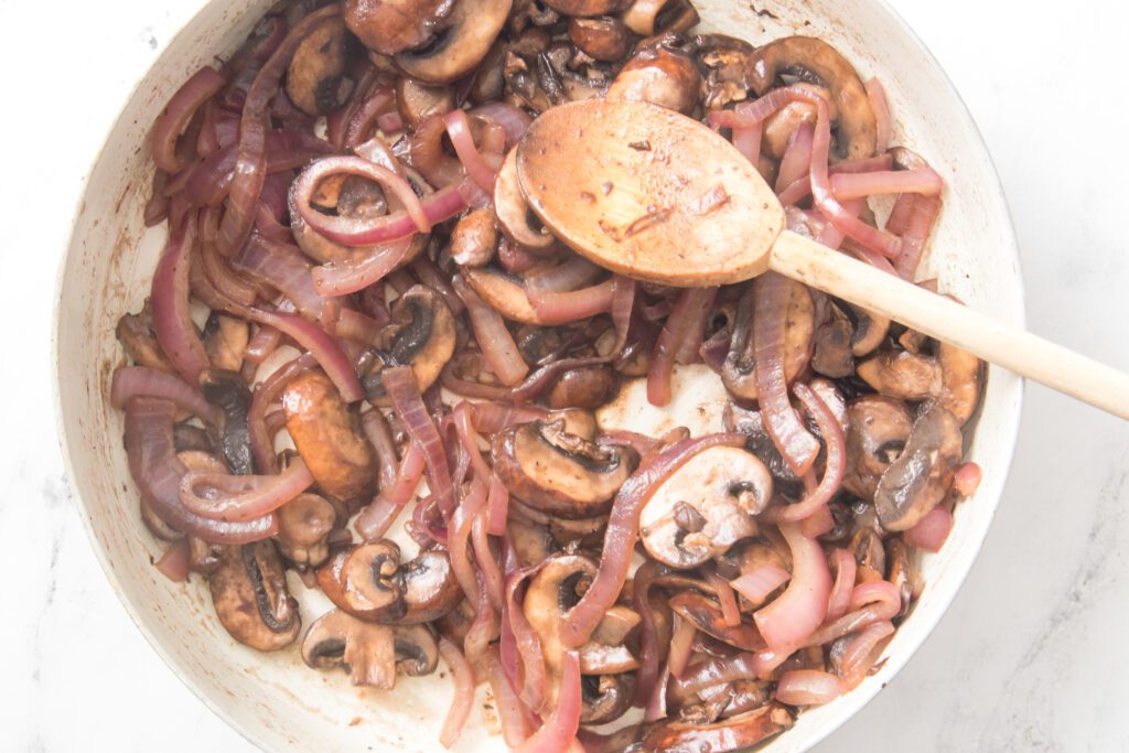 sauteeing onions and mushrooms in skillet