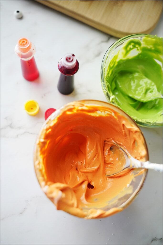bowl of orange and green melted chocolate