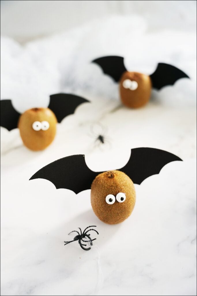 kiwi with bat wings and candy eyes