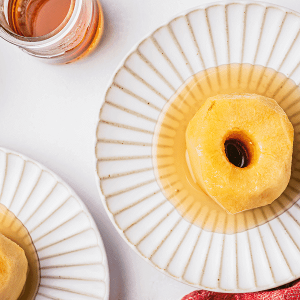 Poached apples on white plates