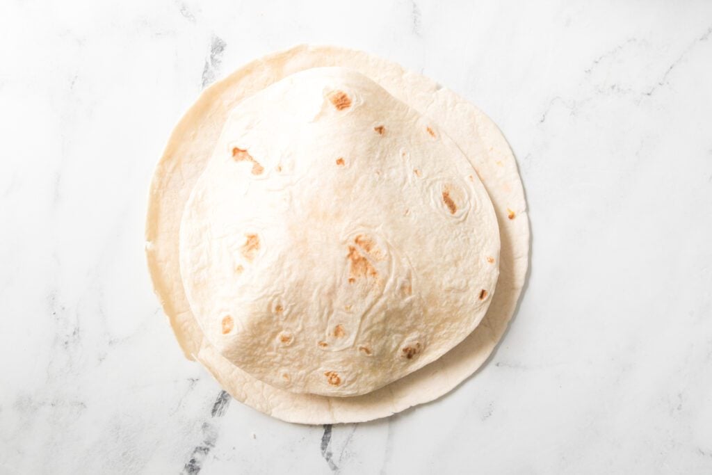 burrito tortilla topped with a taco shell