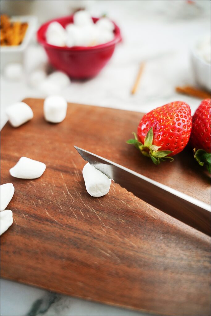 knife cutting mini marshmallow in half diagonally