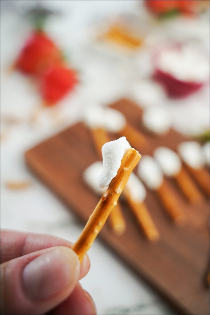 piece of cut mini marshmallow adhered to broken pretzel stick