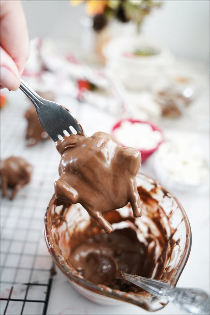 fork holding strawberry that looks like a chocolate turkey
