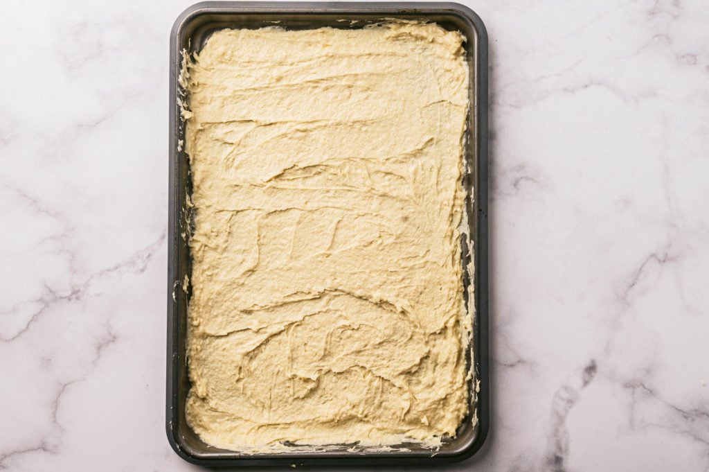 crust batter spread on a baking sheet