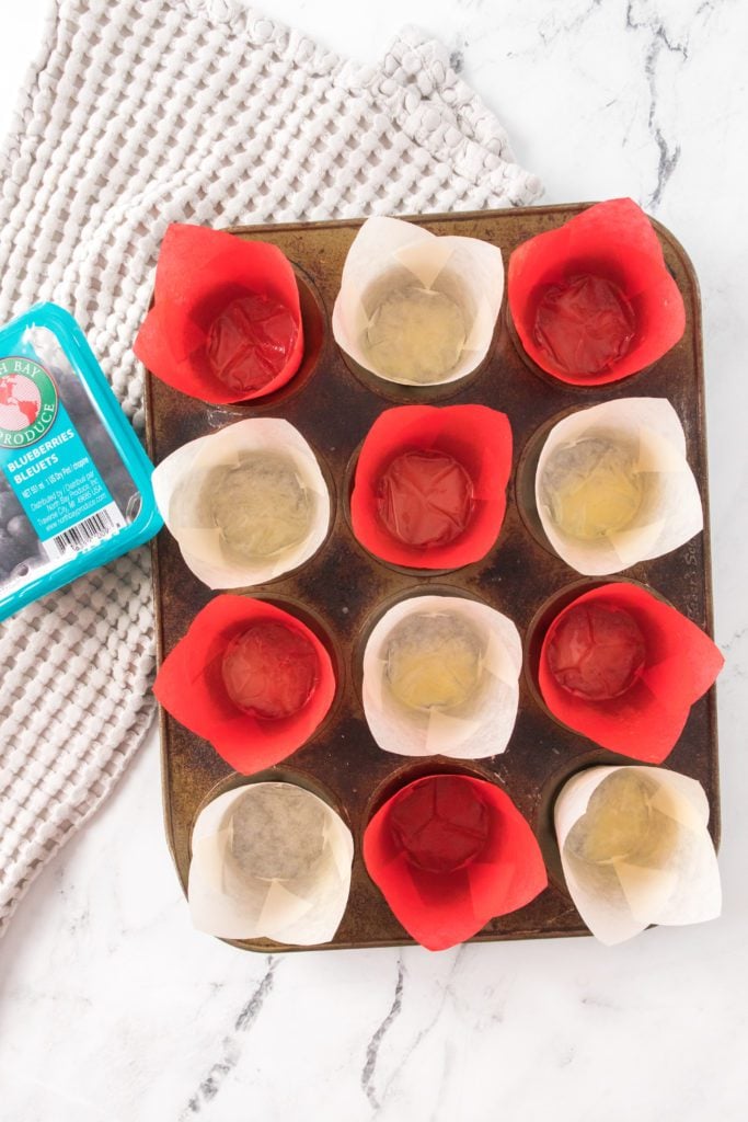 muffin tin with baking cups sprayed with baking spray