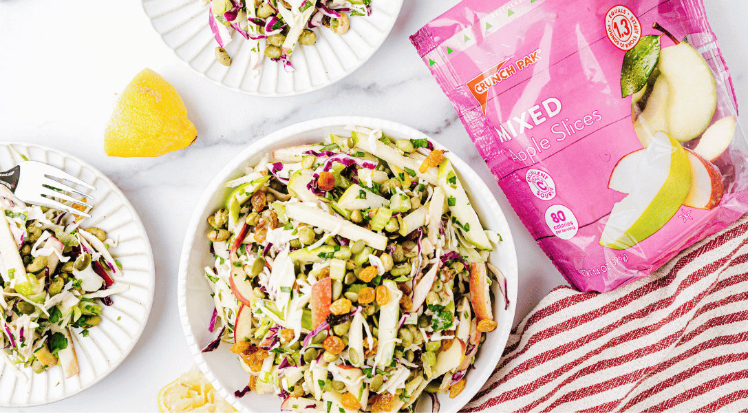 Apple Slaw in Bowl and on 2 white plates with Crunch Pak Apple Slices