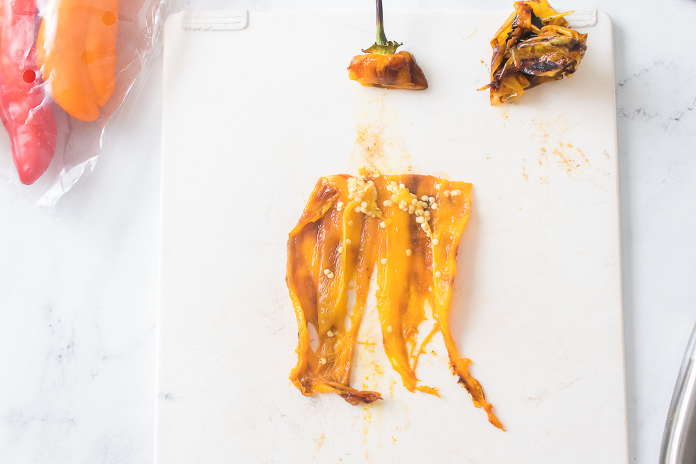 grilled peppers sliced in half on cutting board