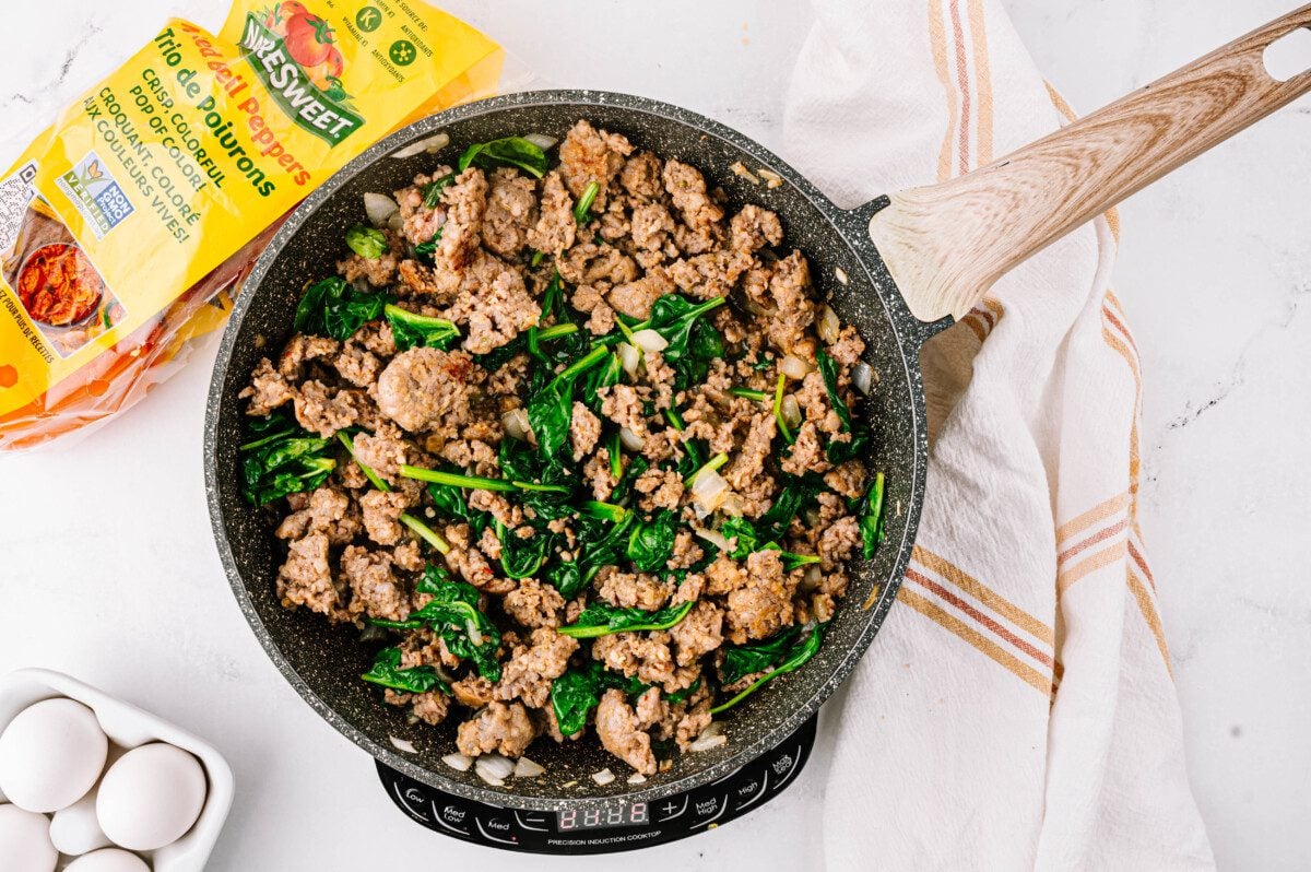 Cook spinach until wilted.