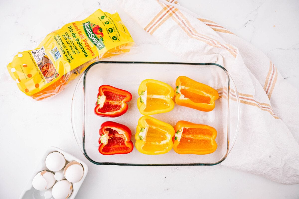 Place cut side of peppers facing up, side by side, in a 9x13 inch baking dish.
