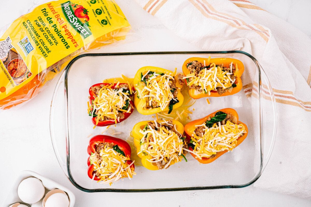 Pour egg mixture into each bell pepper and top with cheese.