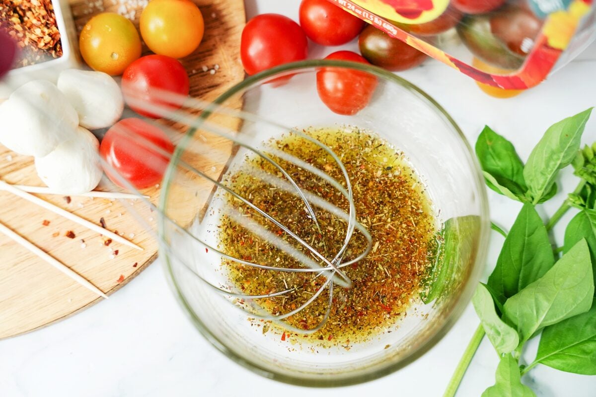 Olive oil, Italian seasoning, cracked red pepper flakes, garlic powder, and salt in a bowl.