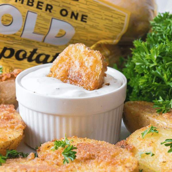 Oven Roasted Parmesan Potatoes on plate with bag and parsley in background