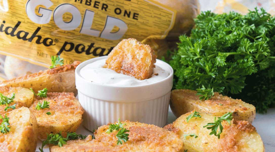 Oven Roasted Parmesan Potatoes on plate with bag and parsley in background