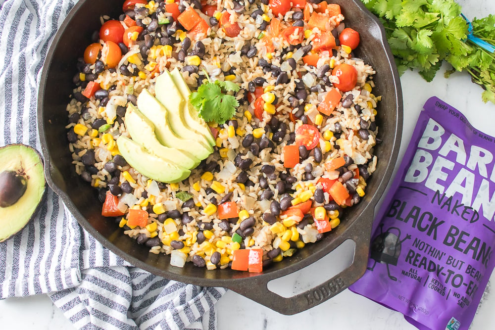 Finished Southwestern Rice in skillet with Bare Beans packaging