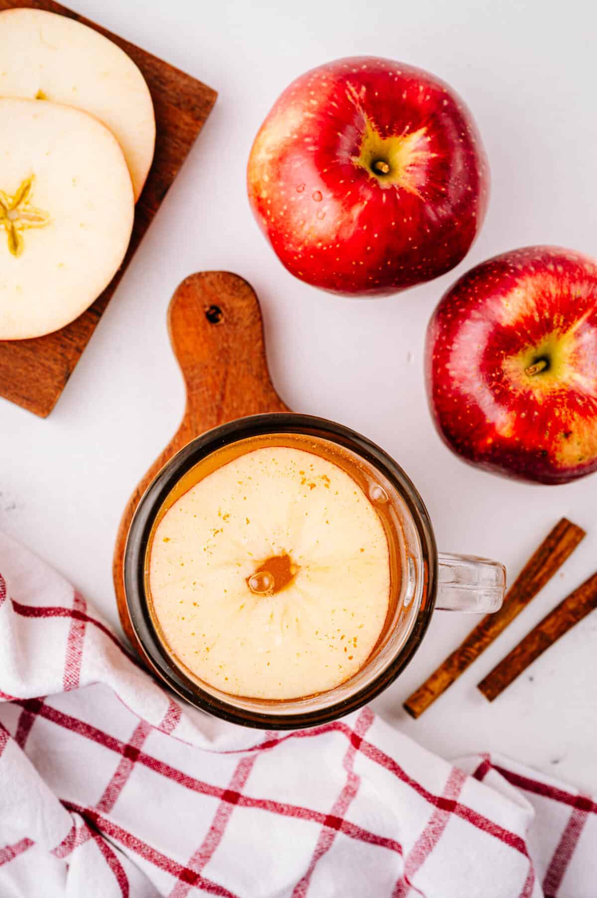 vertical overhead shot of apple ring in mug with hot toddy