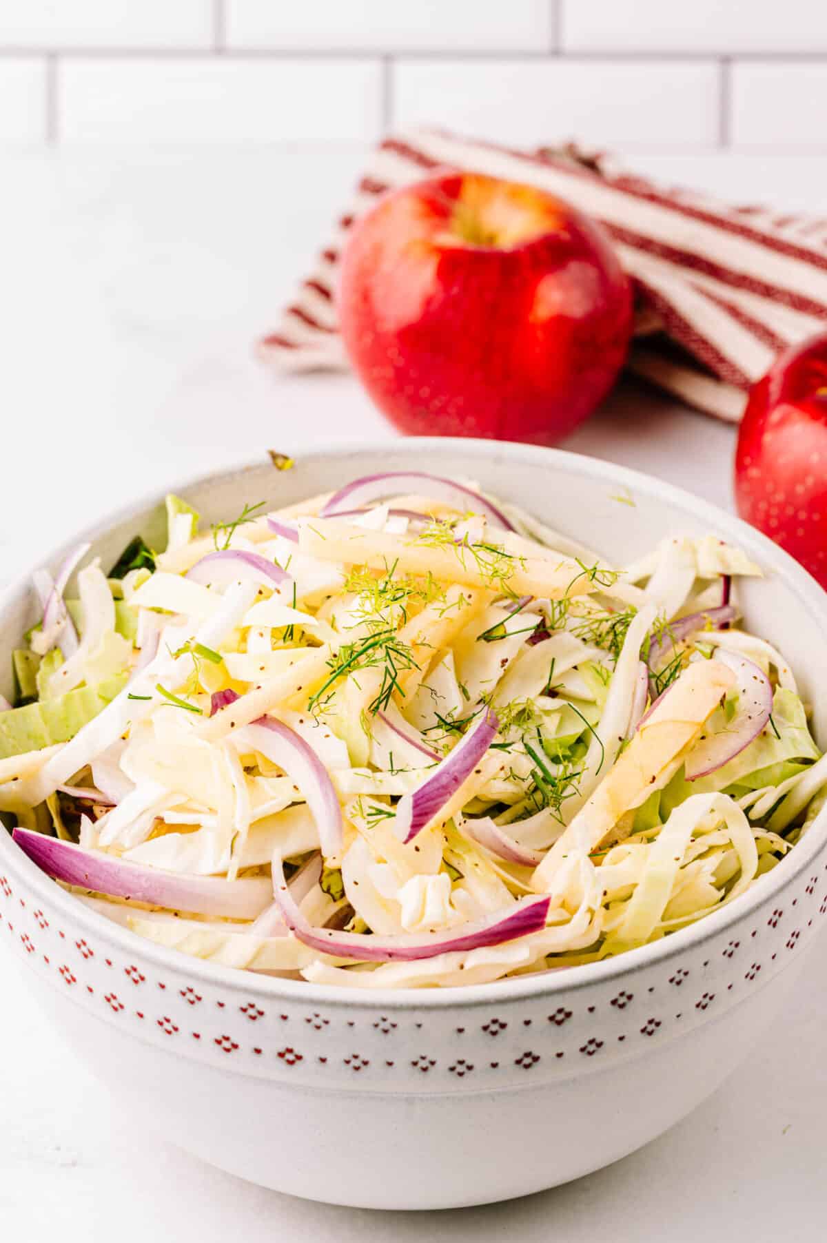 vertical head on shot fennel apple salad in bowl