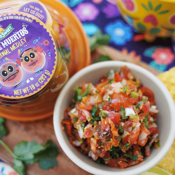 Overview of Salsa in a bowl with NatureSweetยฎ Dia de los Muertos Constellation Tomato packaging