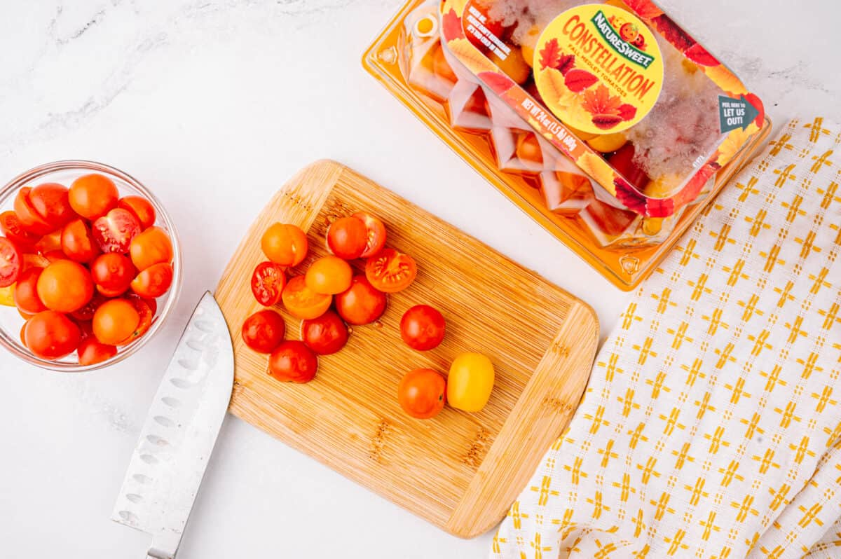 overhead shot of NatureSweet Constellation tomatoes and tomatoes on cutting board with knife