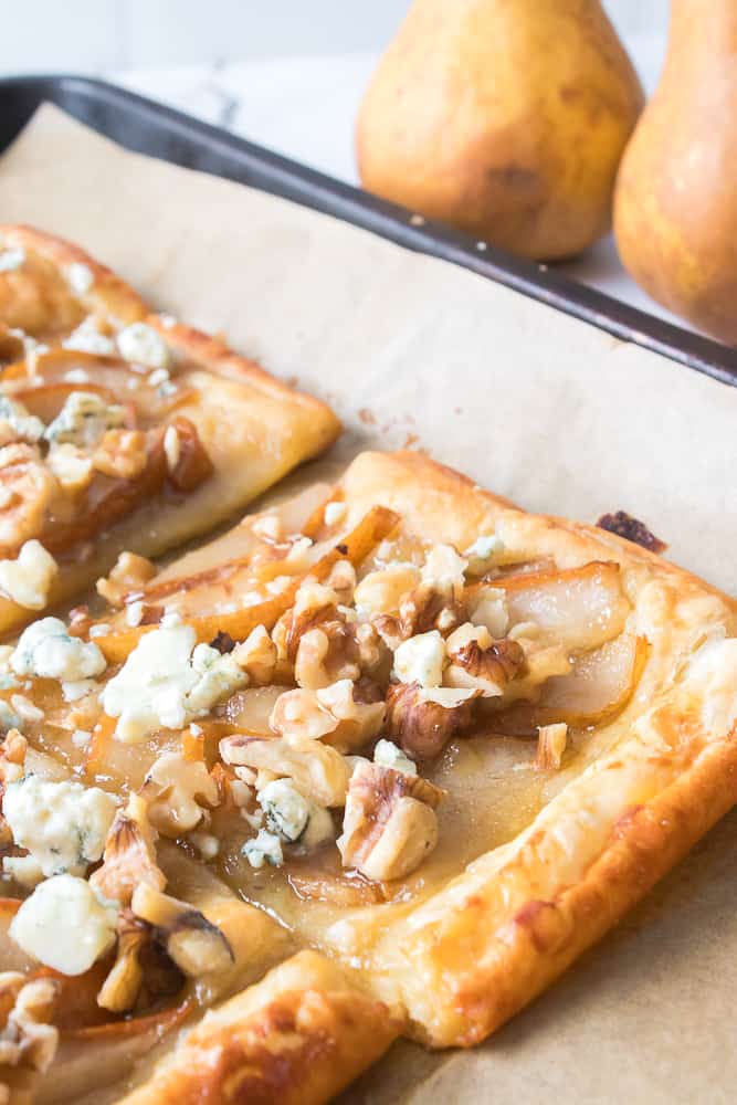 close up vertical shot of pear and blue cheese tartlet