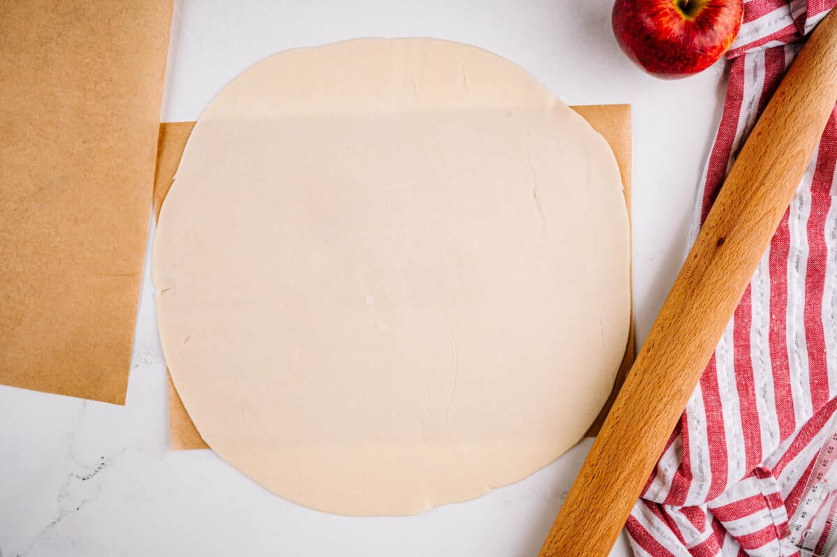 overhead shot of pie crust rolled out on parchment paper