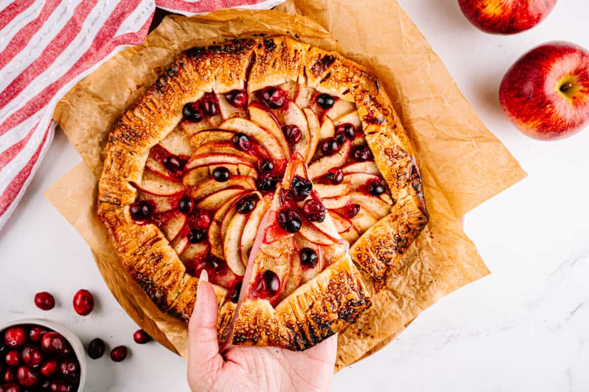 hand holding slice of apple galette