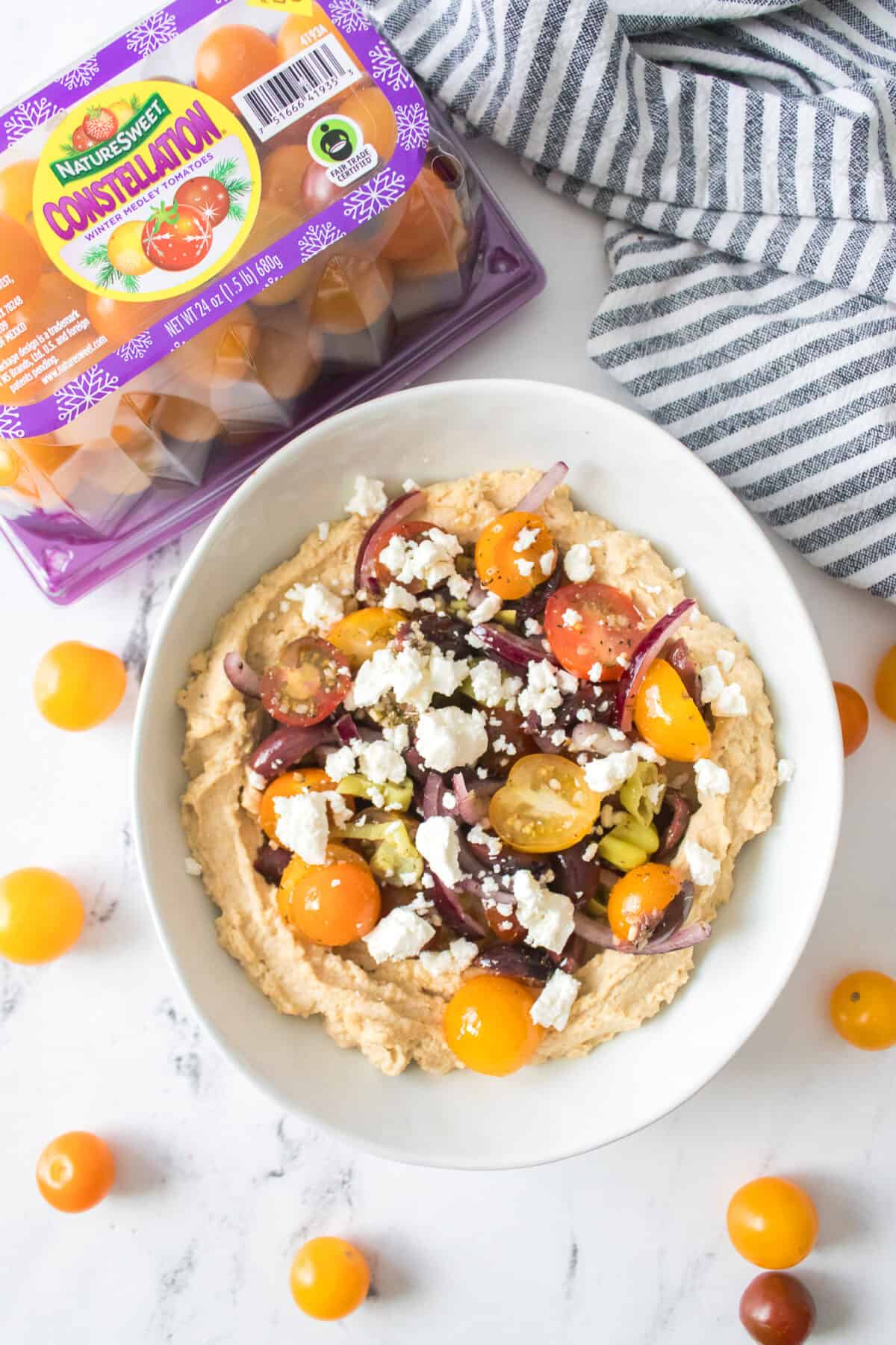 vertical overhead shot of greek hummus in white bowl