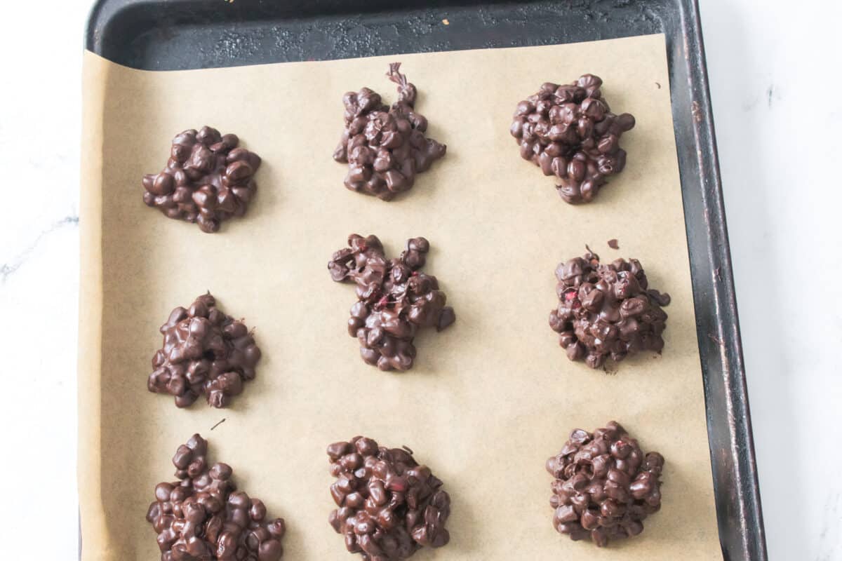Chocolate pomegranate clusters on pan