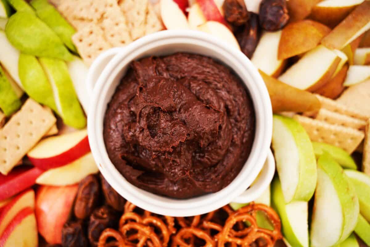 overhead shot of chocolate hummus on serving board