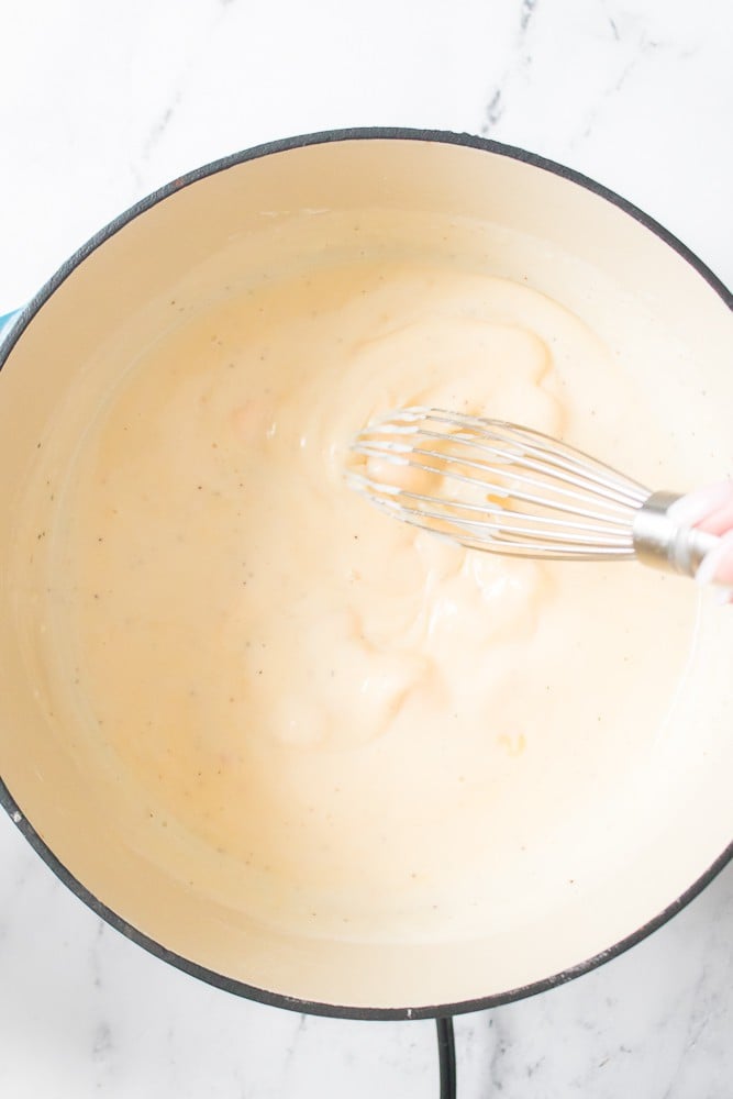 dutch oven melting velvetta while whisking