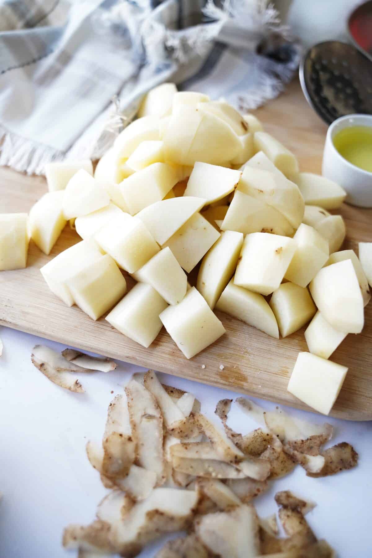 potatoes peeled and cut into 2" pieces on cutting board