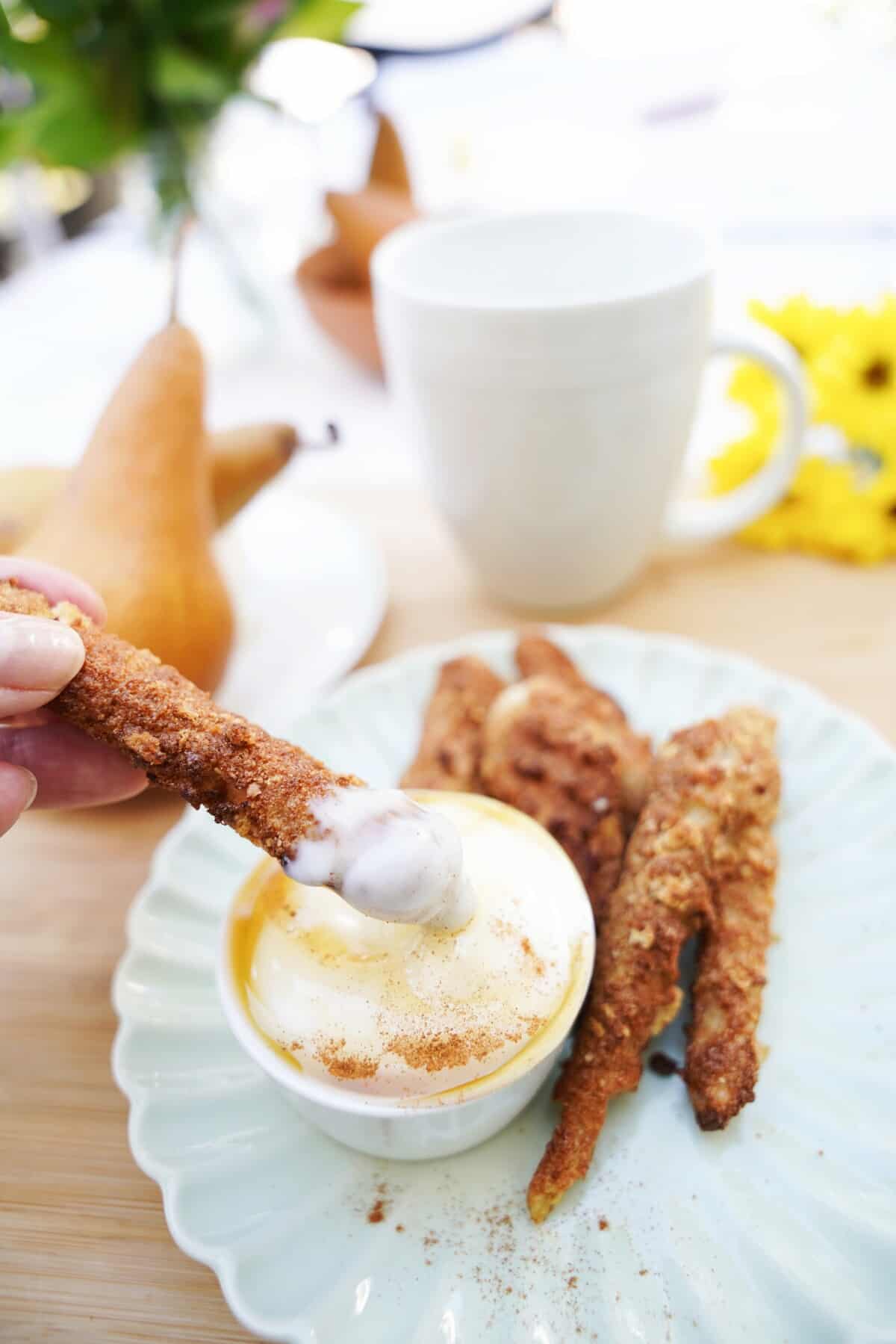 pear fries being dipped into sauce