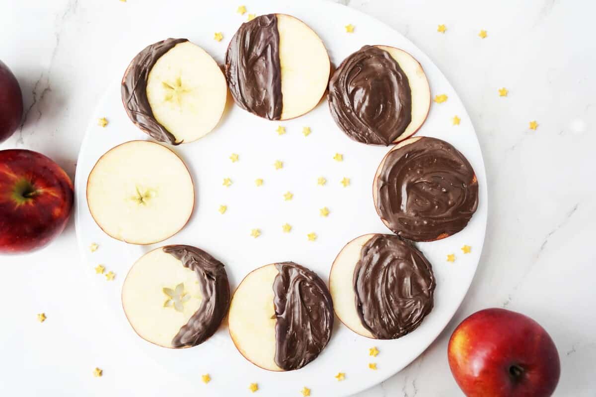 Apple slices covered in chocolate showcasing the phases of the moon