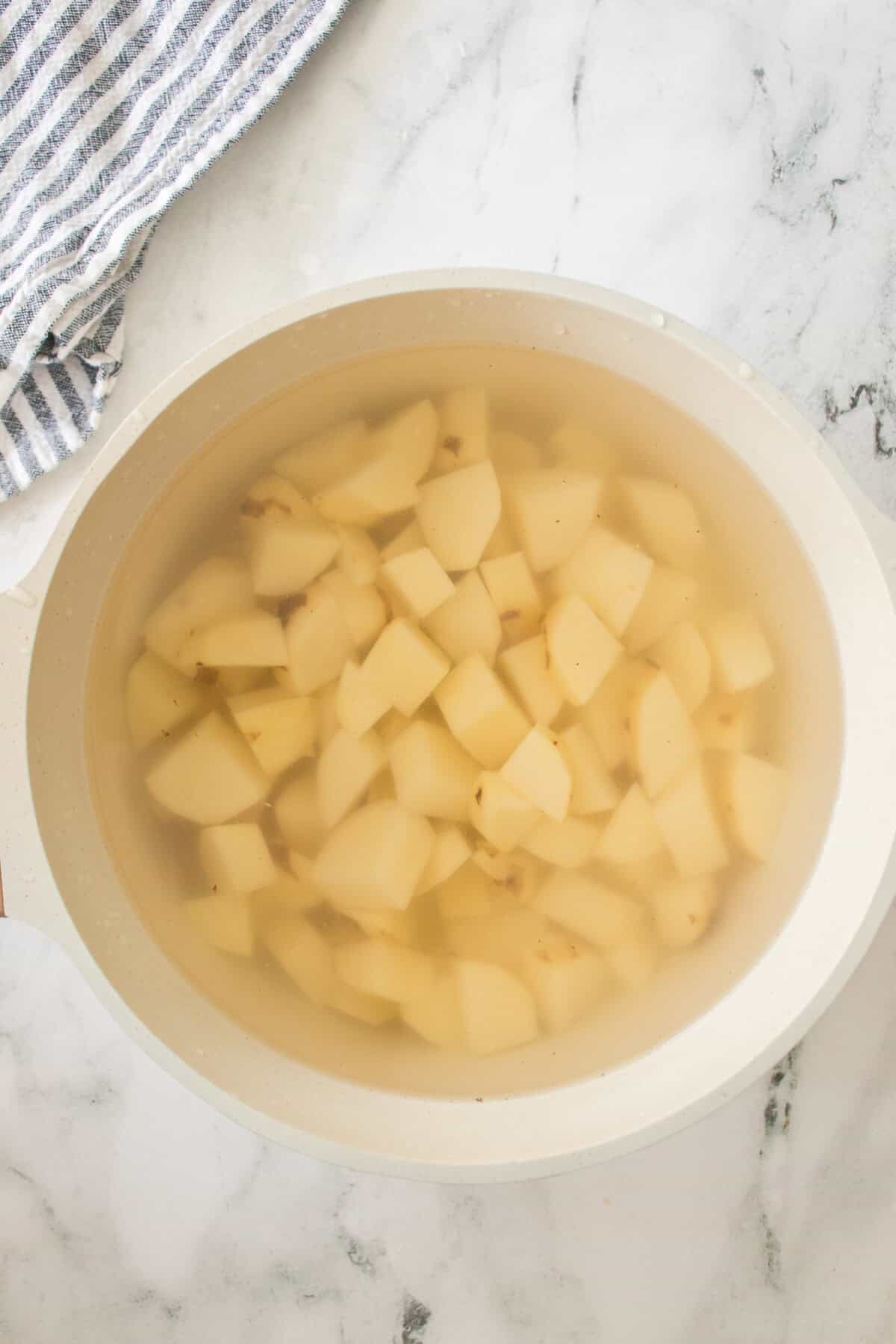 potatoes in water in pan
