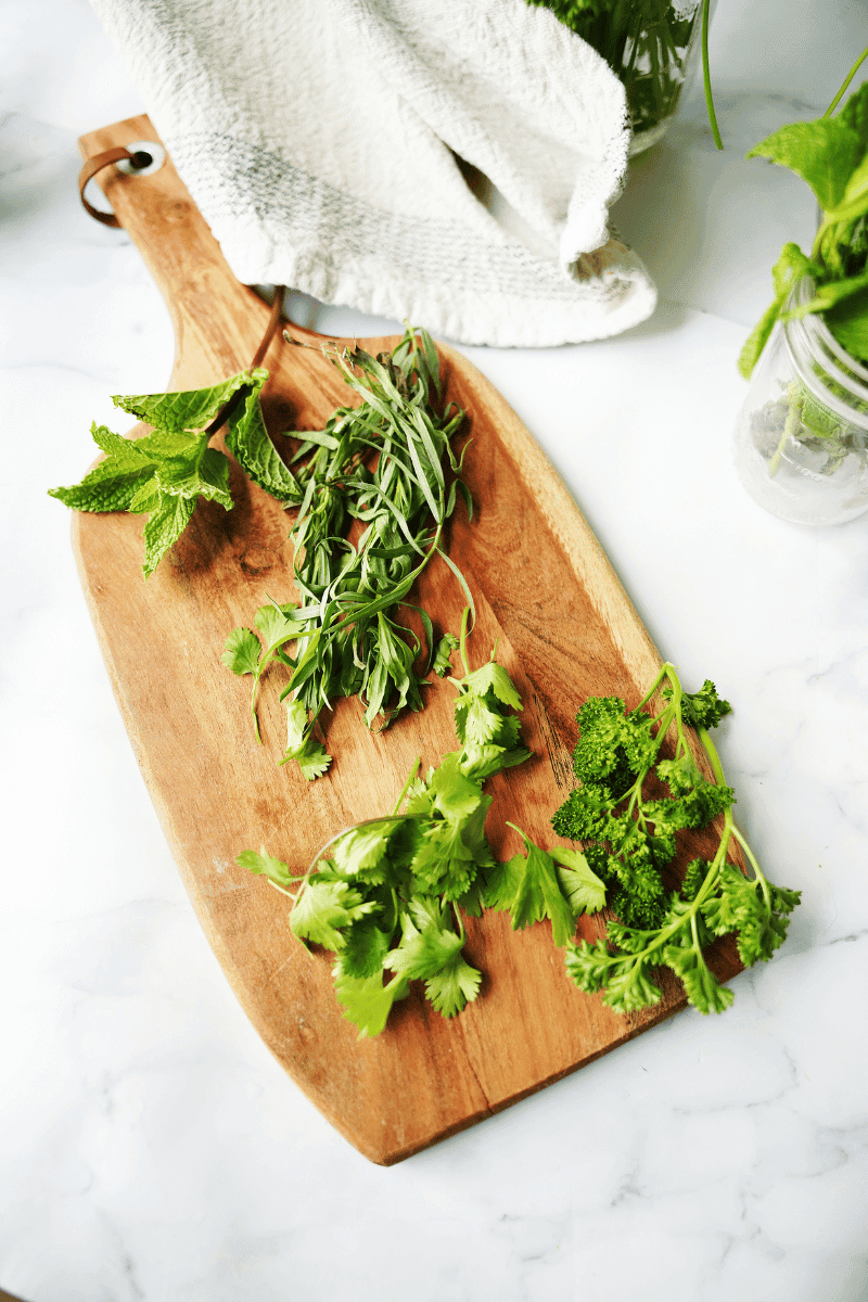 fresh herbs on a cutting board