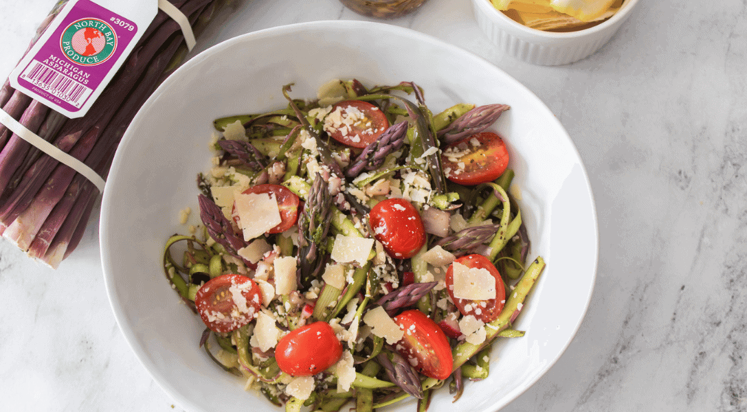 Shaved Asparagus Salad in white bowl with purple asparagus
