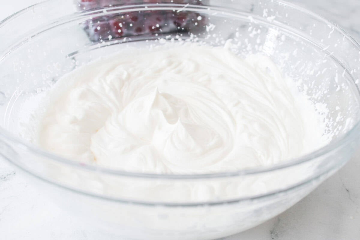 heavy whipping cream whipped to peaks in glass bowl