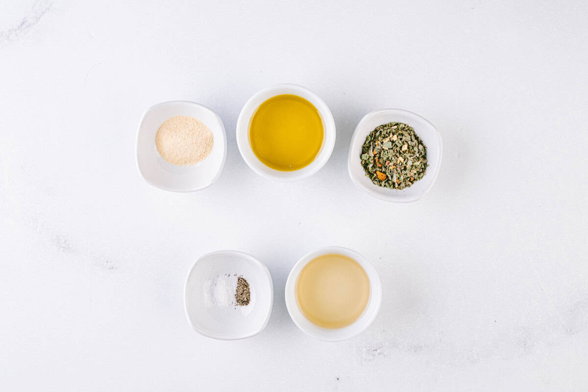 Italian dressing ingredients - olive oil, white wine vinegar, Italian seasoning, garlic powder, salt, and pepper